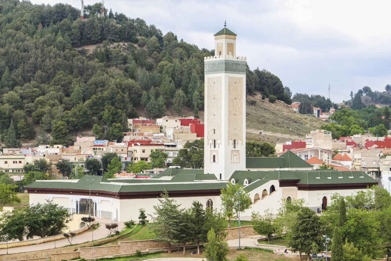 Nour Mosque minaret in Azrou with the town and green hills of the Middle Atlas