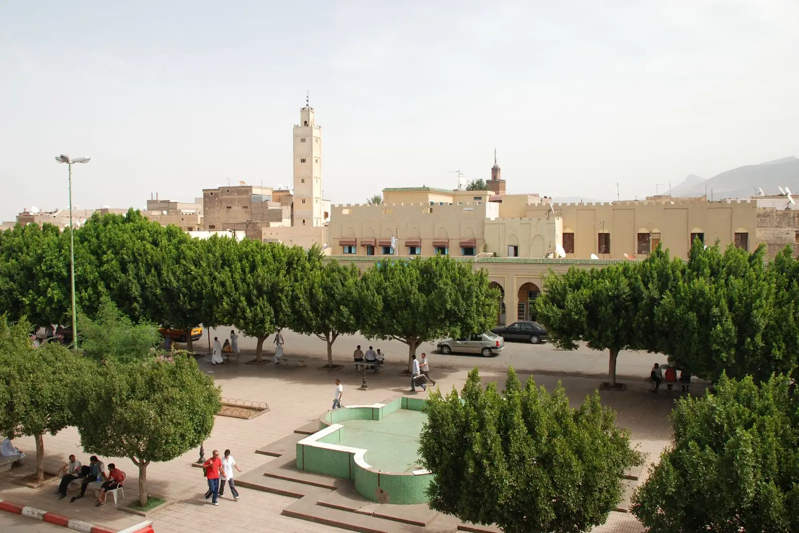 Old city square of Beni Mellal with trees and a minaret