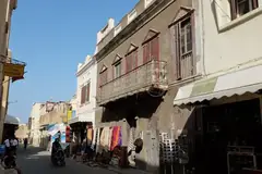 Street of old shopfronts and balconies in El Jadida