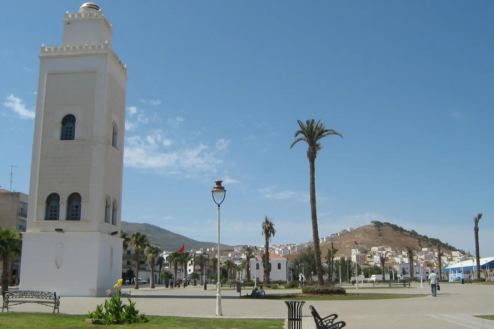 White minaret on the Nador seafront promenade with hills behind