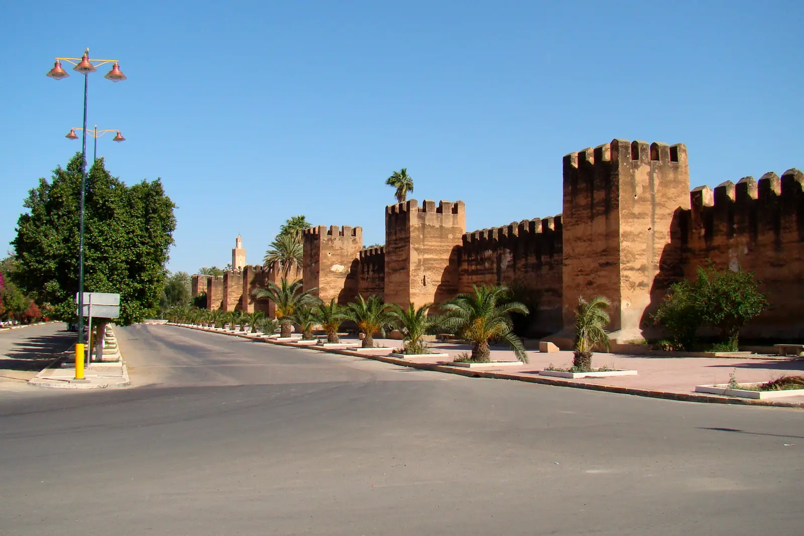 Crenellated earthen city walls of Taroudant beside the road